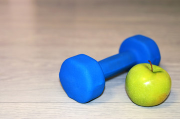 Healthy lifestyle. Dumbbells, Yoga mat, green apple and measuring tape. Sport. Lifestyle.