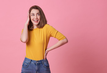 Wall Mural - Excited beautiful woman happiness wearing casual yellow t-shirt isolated on pink background.