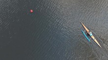 Canoeing Competition-rowing Boating Sport. Athletes Rowers On Outrigger Canoe Boats With Stabilizer In The River Water Area. Aerial Survey 