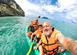 © Mirko Vitali - Senior mother and father with son taking selfie at kayak excursion in Thailand - Adventure travel in south east asia - Elderly and family concept of love sharing moments with parents - Warm vivid look