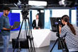 © New Africa - Presenter, director and video camera operator working in studio. News broadcasting