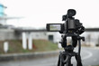 © New Africa - Professional video camera outdoors. Space for text