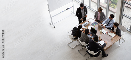 Fotomural Top view of group of multiethnic busy people working in an office, Aerial view w