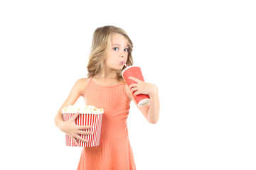young girl holding bucket with popcorn and paper cup on white background