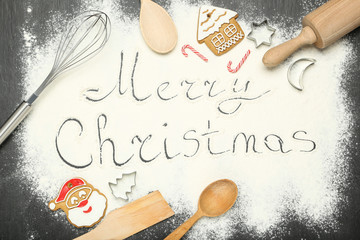 Wall Mural - Text Merry Christmas on flour with cookies and kitchen utensils