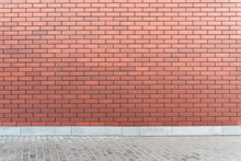 Wall Red Brick Texture With An Asphalt Road. Urban Style Mockup Background. Modern New Brickwall On A Street.