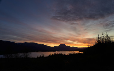 Wall Mural - the orange glow of sunrise over loch maree and the prominent summit of slioch in the north west high