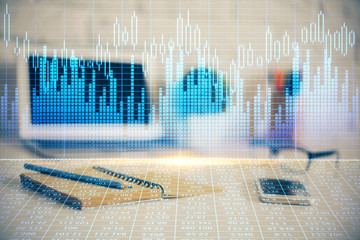 Financial graph colorful drawing and table with computer on background. Double exposure. Concept of international markets.