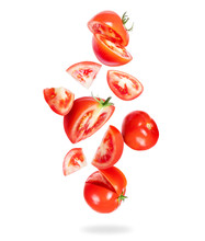 Whole And Sliced Fresh Tomatoes Fall Down On A White Background