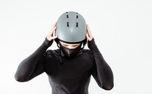 An Athlete Wearing A Sweatshirt And Helmet Prepares For Sport. The Concept Of Playing Sports, Extreme Sport. Putting On The Necessary Protective Clothing.