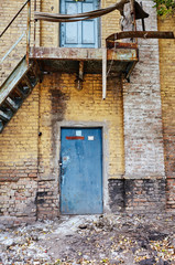 Wall Mural - Old vintage wall with worn metal door and stairs