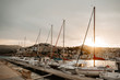 © Jesus Zapatero/ADDICTIVE STOCK - Sea port with white yachts and boats in city with buildings on hills at beautiful sunset with cloudy sky