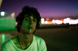 © Rafa Cortes/ADDICTIVE STOCK - Handsome provocative confident guy in casual clothes with cigarette in mouth looking with interest at camera against blurred background of street under purple sky during sunrise