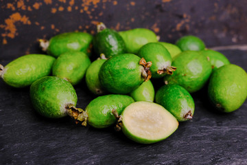 Tropical ripe feijoa fruit or acca on black board. 