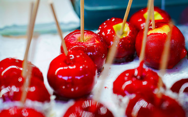 Wall Mural - Lollipop candies or Red Apples with caramel in Christmas market in Lithuania Europe in winter. Sweet food at Lithuanian Night street Xmas and holiday fair European city or town, December. Vilnius