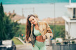 Portrait of young beautiful fit woman, wearing green activewear, athlete model posing outside, sport fashion