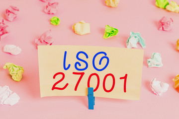 Word writing text Iso 27001. Business photo showcasing specification for an information security analysisagement system Colored crumpled papers empty reminder pink floor background clothespin