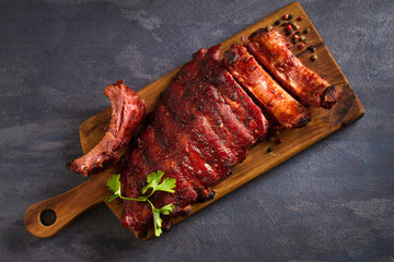 Pork loin ribs served on chopping board. View from above, top