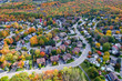 Aerial View of Residential Neighbourhood in Montreal Showing Trees Changing Color During Fall Season in Quebec, Canada