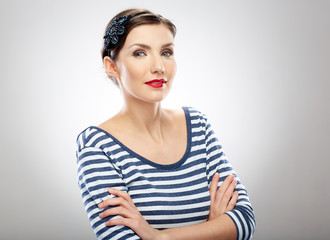 Wall Mural - young woman in striped dress standing with crossed arms.