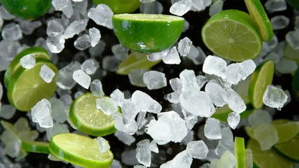 Limes with ice cubes exploding on black background. Super slow motion at 1000 fps.