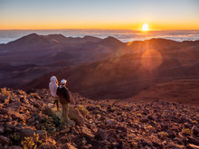 Man And Woman Couple Checking Out The Sunrise At Haleakala  National Park In Maui, Hawaii.