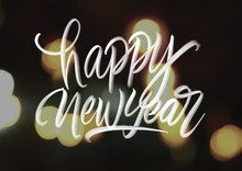 Happy New Year Hand Lattering On Bokeh Background
