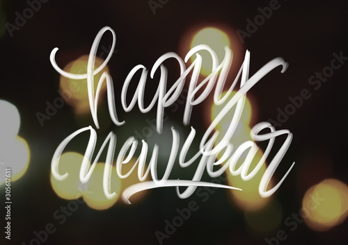 Photographie Happy new year hand lattering on bokeh background