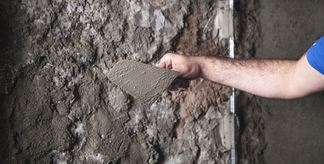 Wall Mural - Caucasian worker plastering wall. Construction work