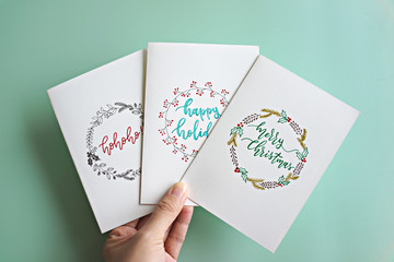 Hand holding hand drawn Christmas greeting card