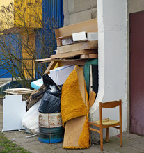 Cardboard Boxes And Old  Broken Furniture At The Garbage Dump Near The Apartment Building