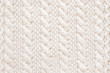 Cable knitting stitch pattern, soft woolen handmade knitted clothes texture.