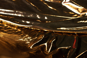 abstract background gold cloth or liquid gold. low key,