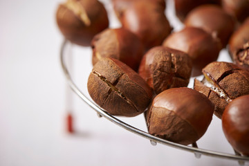 Canvas Print - Roasted chestnuts on metal grill 