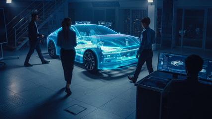 Fototapete - Automobile Engineers Designing Electric Car, Using CAD Software with 3D Holographic Projection Model of a Car Concept. In Automotive Innovation Facility Virtual Vehicle Design with Mixed Technology.