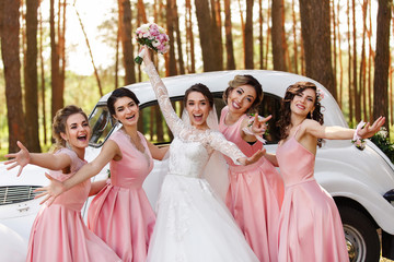 Wedding ideas. Bride and bridesmaids having fun on wedding day