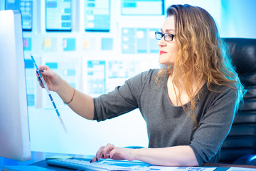 Wall Mural - ux designer holds a palette in his hands. workplace application designer. girl chooses a color. devi