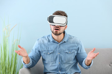 Sticker - Young man with virtual reality glasses at home