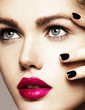 Close-up beauty portrait of beautiful model with bright make-up and manicure. Black nails, pink lips