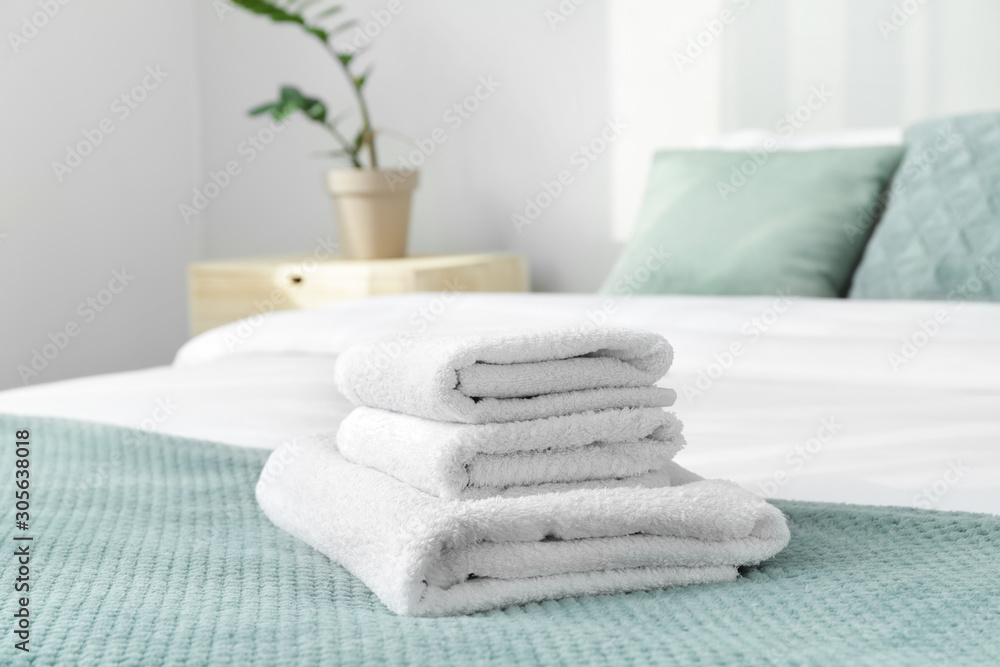 Clean soft towels on bed