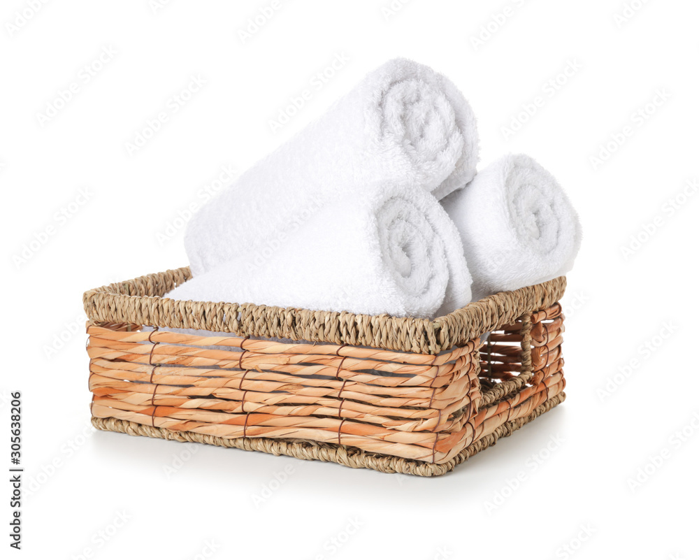 Wicker tray with clean towels isolated on white