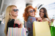 © NDABCREATIVITY - Shopping, fun and tourism concept. Beautiful girls with shopping bags in ctiy
