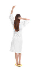 Wall Mural - Young woman in bathrobe on white background