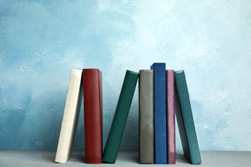 Collection of old books on grey wooden shelf