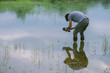 © vipubadee - Photographer shoots photo with reflection clouds. Behind the scene of photography working concept. Free from copy space.