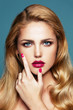 Close-up portrait of beautiful woman with bright make-up and manicure