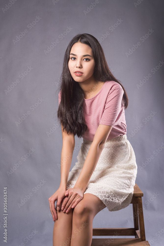 teen asian casting young attractive girl with long black hair on grey background in Studio.  teen girl on casting. classic portrait Stock Photo | Adobe Stock