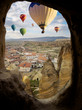 Flight Hot air balloons in Cappadocia - view on mountain landscape of cave town Goreme in Turkey.