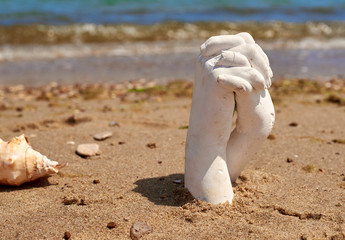 plaster cast of two hands on the seashore