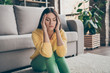 © deagreez - Close up photo of frustrated ill girl sit floor suffer headache migraine pain have health problems close eyes in house living room